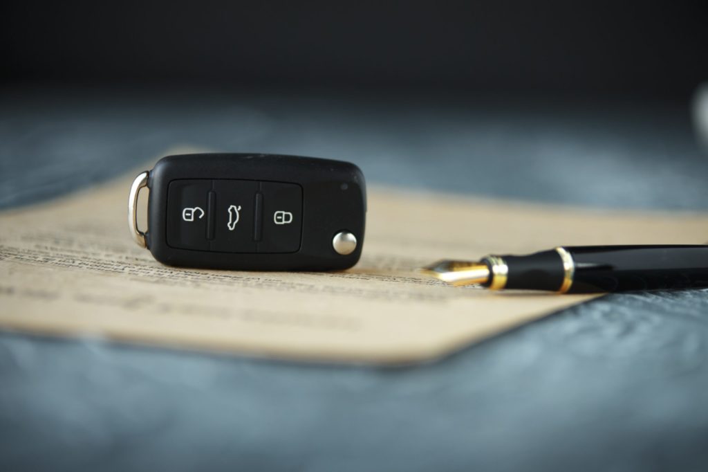 Privacy Help with buying a car Black car key on a signed contract